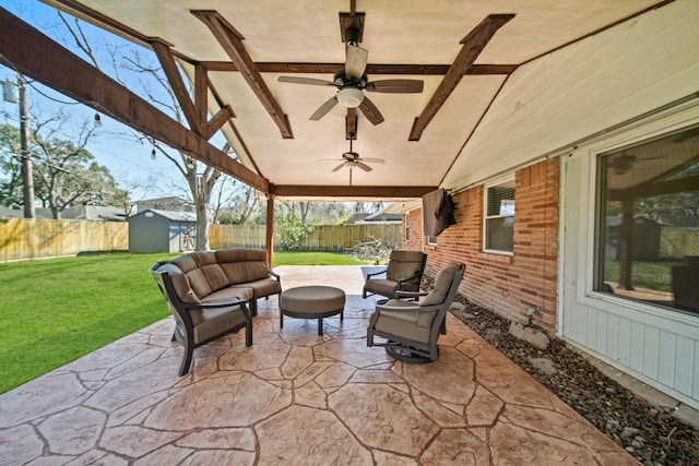 view of patio featuring a shed, an outdoor structure, a fenced backyard, and a ceiling fan