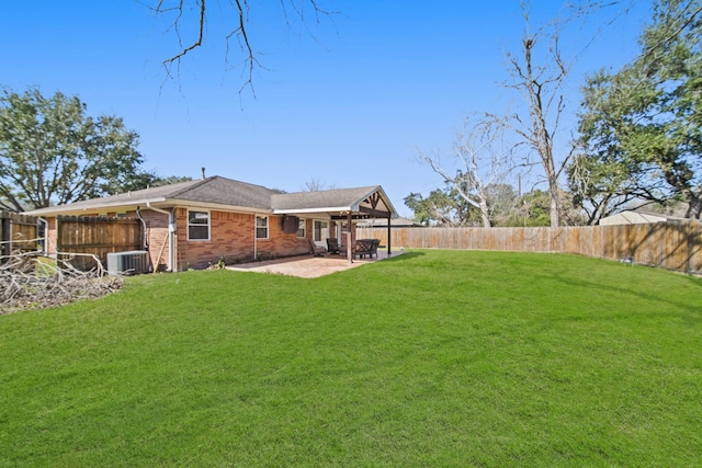 view of yard featuring a fenced backyard, a patio, and central AC