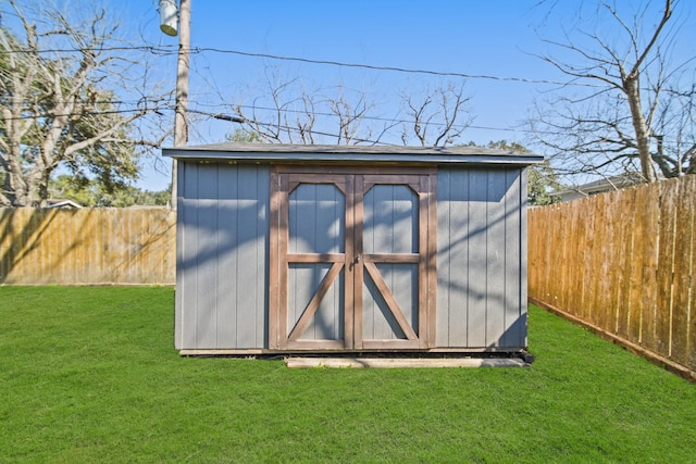 view of shed with a fenced backyard