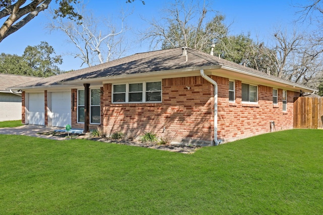 single story home with a front yard, brick siding, driveway, and an attached garage