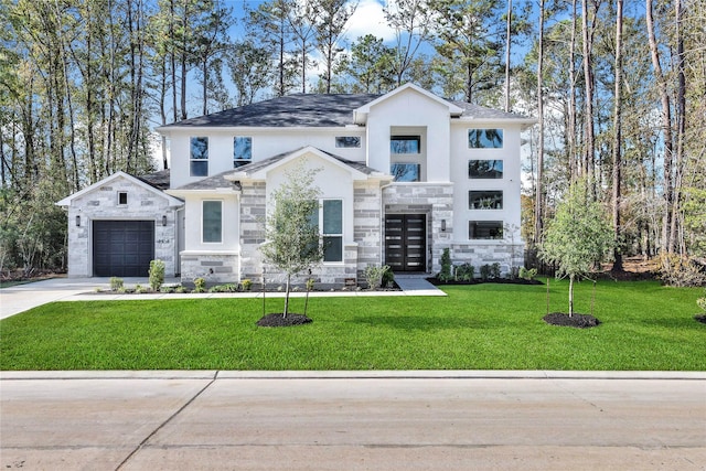 view of front of home featuring driveway, a garage, stone siding, a front yard, and stucco siding