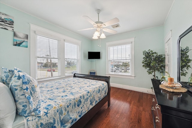 bedroom featuring visible vents, multiple windows, baseboards, and dark wood finished floors