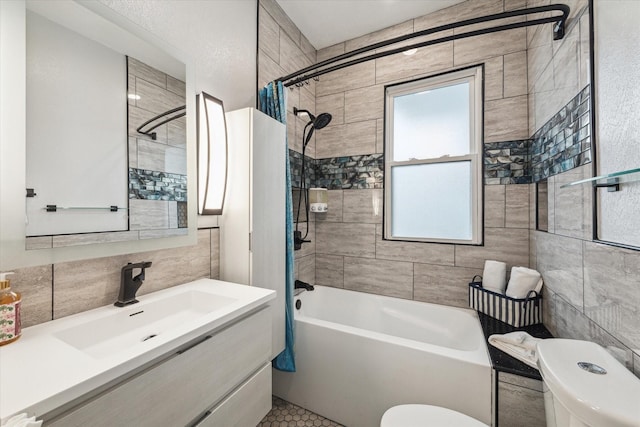 bathroom with tile walls, tasteful backsplash, bathtub / shower combination, toilet, and vanity