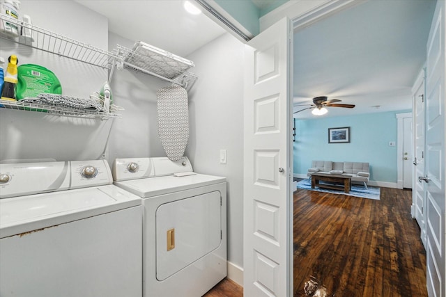 washroom featuring dark wood-type flooring, washing machine and dryer, ceiling fan, laundry area, and baseboards