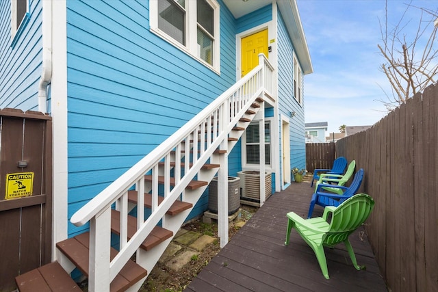 deck featuring central AC, fence, and stairs