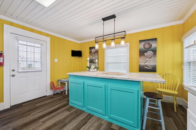 kitchen featuring light stone counters, dark wood-style flooring, a kitchen breakfast bar, a center island, and pendant lighting