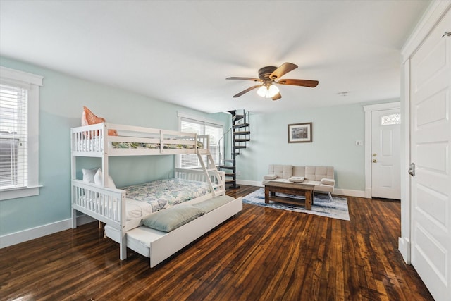 bedroom with ceiling fan, baseboards, and dark wood-type flooring