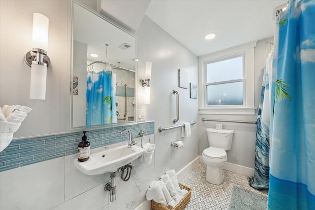 full bathroom with visible vents, decorative backsplash, toilet, a sink, and tile patterned flooring