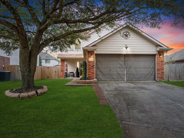 view of front of home featuring brick siding, an attached garage, and fence