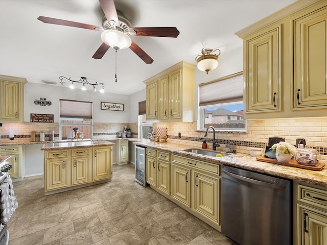 kitchen featuring beverage cooler, light stone countertops, a sink, cream cabinetry, and dishwasher