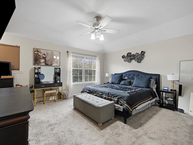 carpeted bedroom featuring vaulted ceiling and a ceiling fan