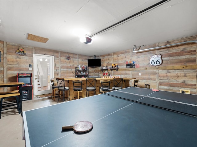 playroom with a bar and concrete flooring