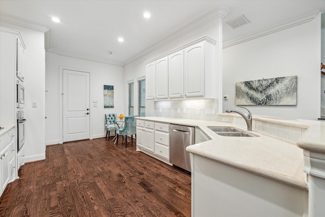 kitchen featuring stainless steel appliances, light countertops, white cabinets, and a sink