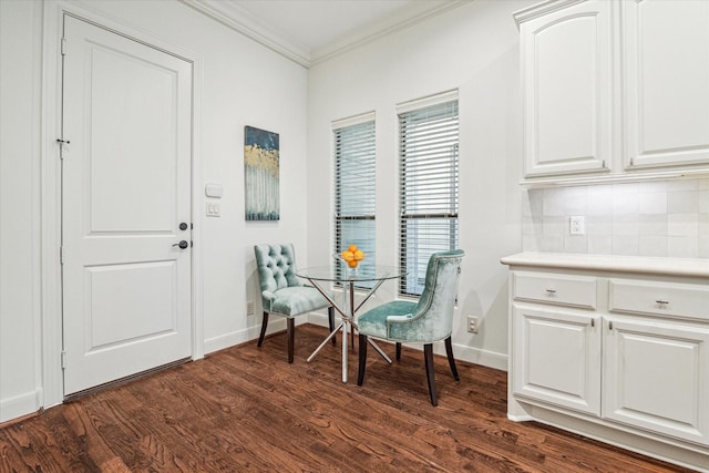 living area featuring baseboards, dark wood-type flooring, and crown molding