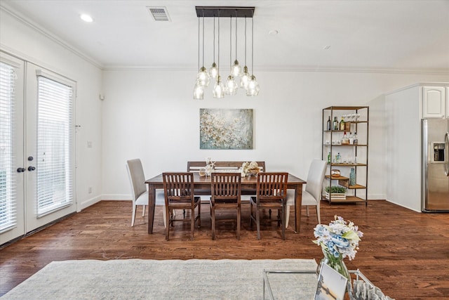 dining area featuring baseboards, visible vents, ornamental molding, dark wood-style flooring, and french doors