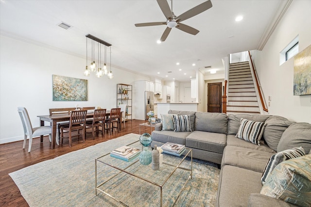 living area featuring ornamental molding, recessed lighting, visible vents, and dark wood-style floors