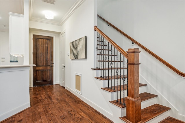 interior space with baseboards, ornamental molding, and dark wood finished floors