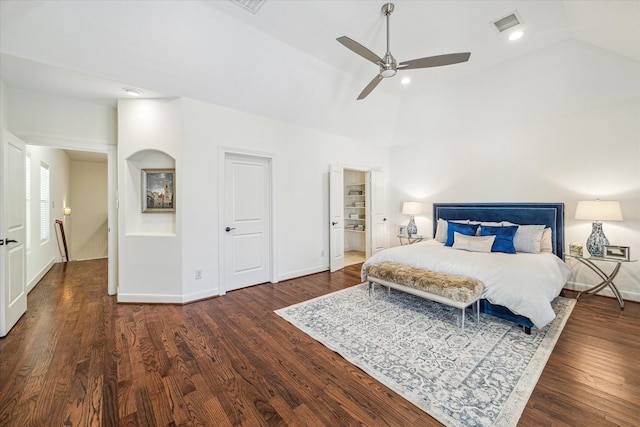 bedroom with vaulted ceiling, visible vents, dark wood finished floors, and baseboards