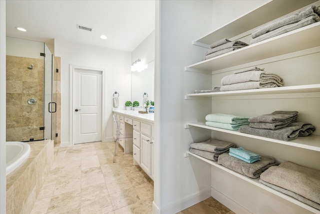 full bath with a garden tub, recessed lighting, a stall shower, vanity, and baseboards