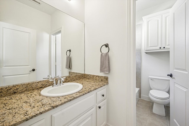 full bathroom with tile patterned flooring, baseboards, vanity, and toilet