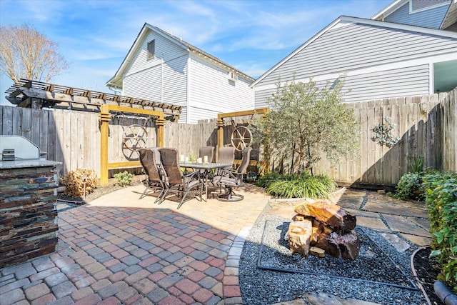 view of patio / terrace featuring outdoor dining space, area for grilling, a fenced backyard, and a pergola