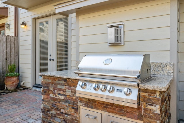 view of patio featuring fence, grilling area, and area for grilling