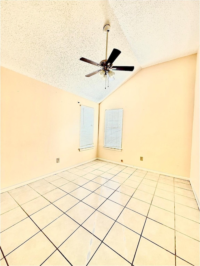 spare room featuring vaulted ceiling, ceiling fan, and a textured ceiling