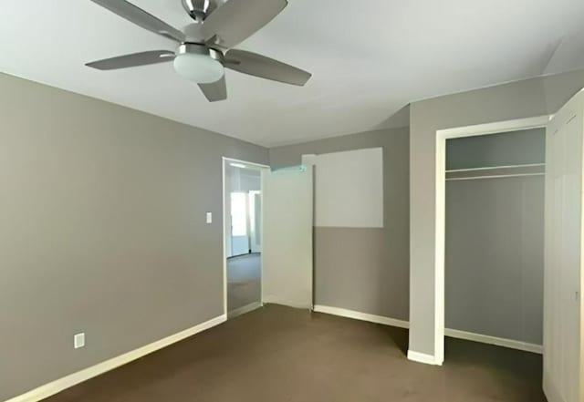 unfurnished bedroom with a closet, dark carpet, a ceiling fan, and baseboards