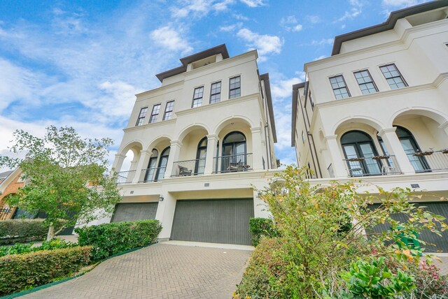 314 W Clay St, Houston, TX 77019 - mediterranean / spanish-style home with a balcony, an attached garage, stucco siding, and decorative driveway