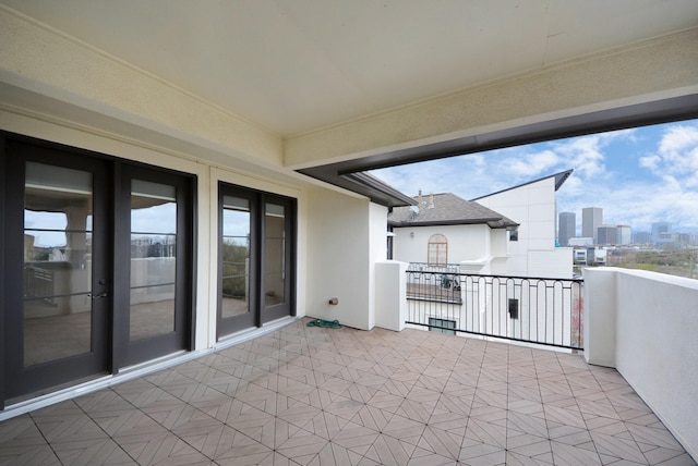 view of patio with a view of city and a balcony