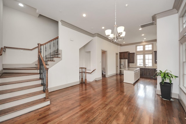 living room featuring dark wood-style floors, recessed lighting, visible vents, an inviting chandelier, and ornamental molding