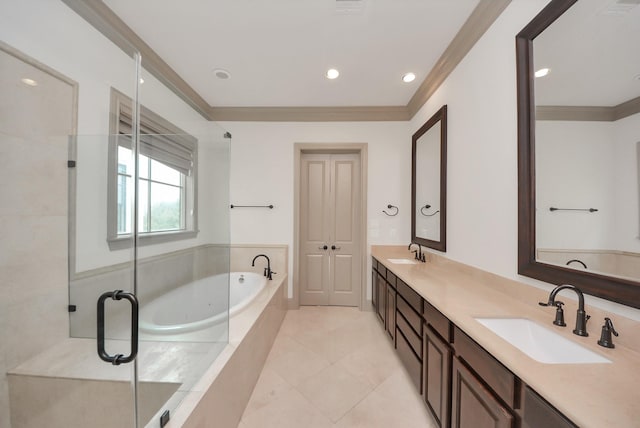 bathroom featuring a garden tub, double vanity, ornamental molding, and a sink