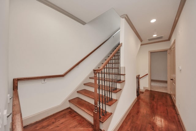 stairs with crown molding, recessed lighting, visible vents, wood finished floors, and baseboards