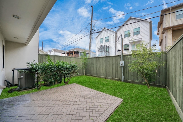 view of yard with cooling unit, a patio area, a residential view, and a fenced backyard