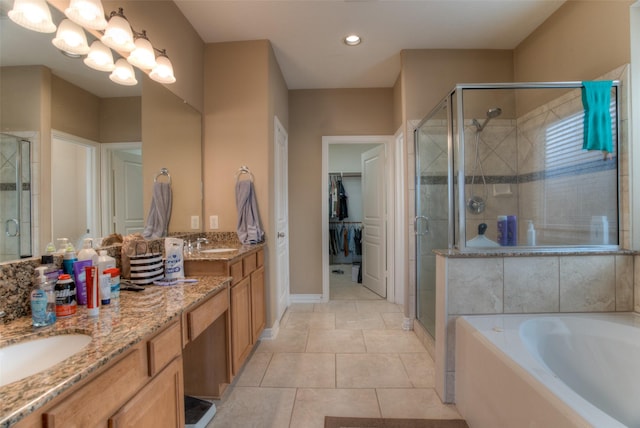 full bath featuring a sink, a spacious closet, a shower stall, and double vanity