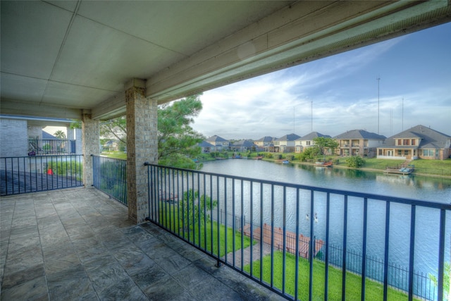 balcony featuring a water view and a residential view