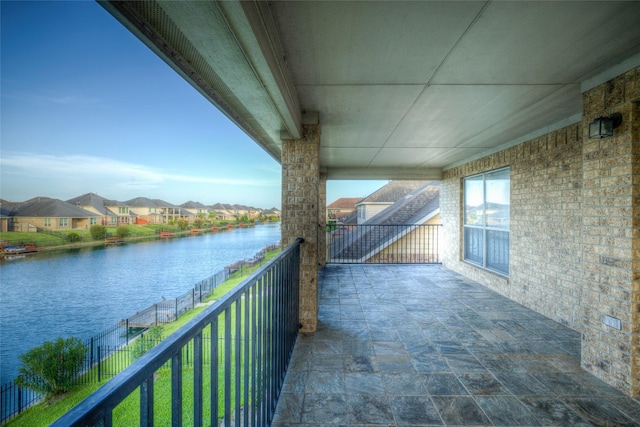 balcony featuring a water view and a residential view