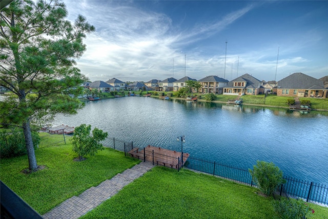 water view with a residential view and fence