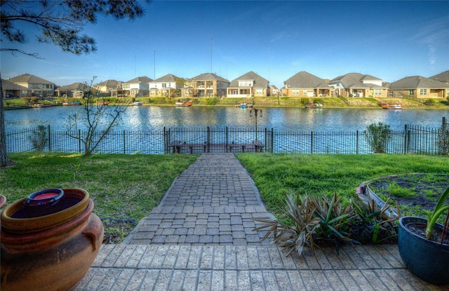 property view of water with fence and a residential view