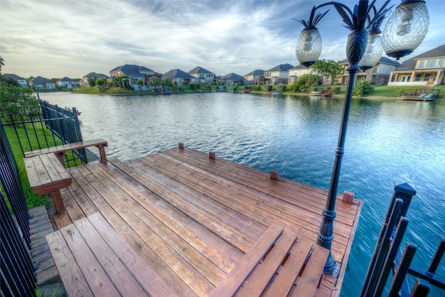 dock area with a water view and a residential view