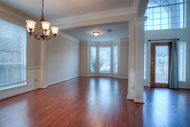 entryway with ornamental molding, dark wood-type flooring, and decorative columns