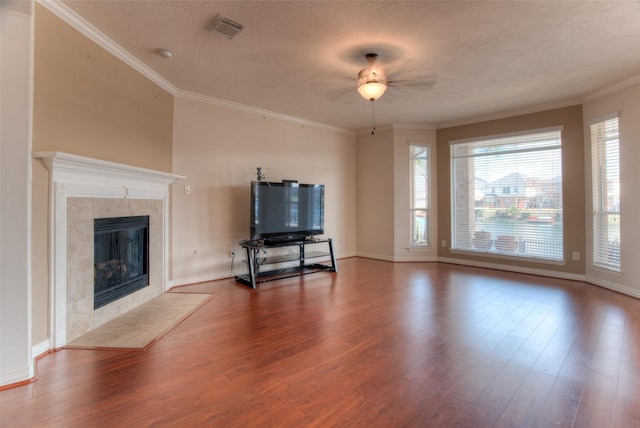 unfurnished living room with a textured ceiling, a fireplace, wood finished floors, and visible vents