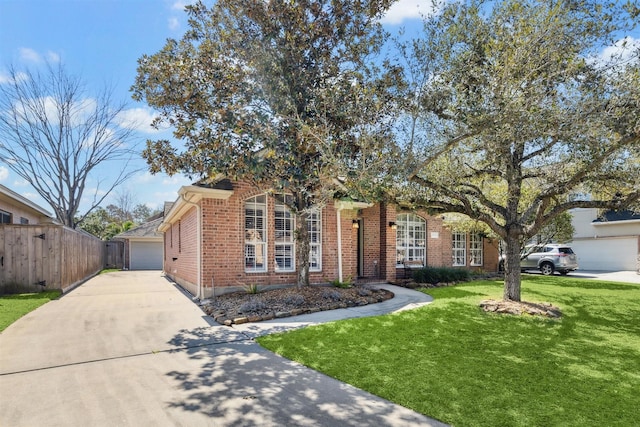 view of front of property with a garage, fence, a front lawn, and brick siding