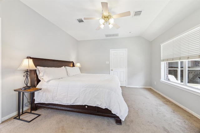 carpeted bedroom with vaulted ceiling, visible vents, and baseboards