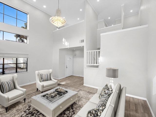 living area with a wealth of natural light, visible vents, and light wood-style floors