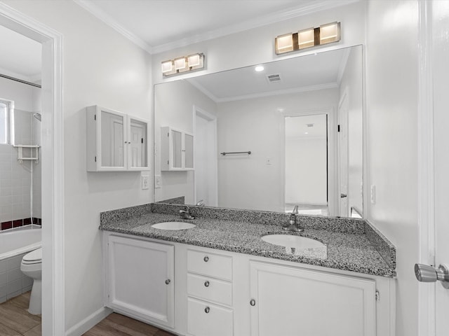 full bath featuring double vanity, visible vents, ornamental molding, and a sink