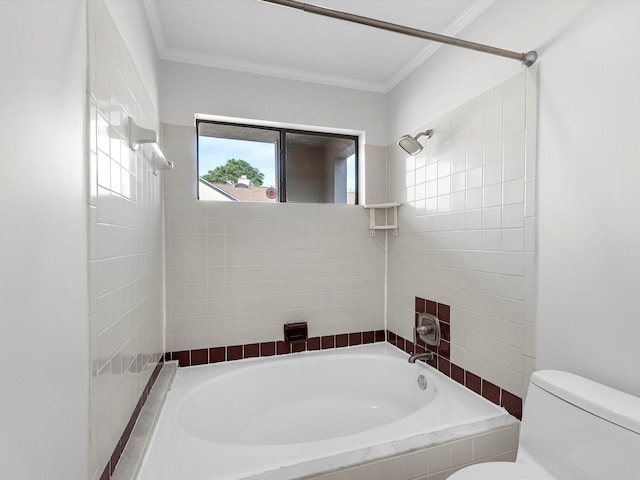 bathroom with tiled shower / bath, ornamental molding, and toilet