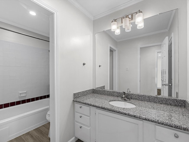 bathroom with bathing tub / shower combination, toilet, ornamental molding, wood finished floors, and vanity