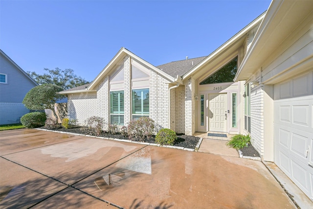 property entrance featuring brick siding