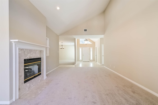 unfurnished living room featuring a fireplace, light colored carpet, visible vents, high vaulted ceiling, and baseboards